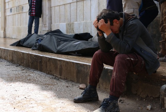 A Syrian man cries next to a body in Azaz, northern Syria.