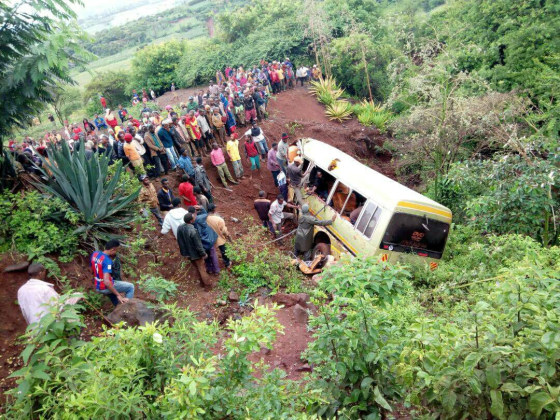 Image: Residents gather at the scene of an accident that killed schoolchildren, teachers and a minibus driver along the Arusha-Karatu highway in Tanzania's northern tourist region of Arusha