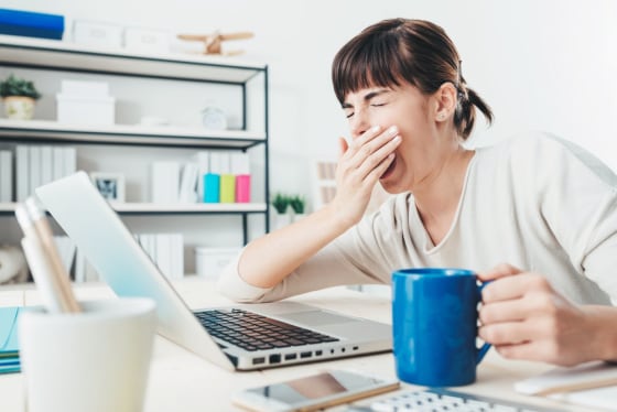 Image: Woman yawning at work