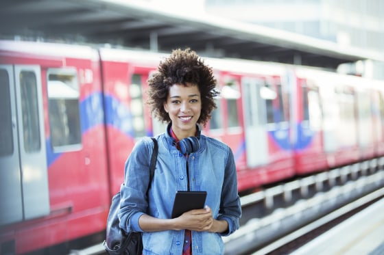 Image: A woman smiles inside a train station