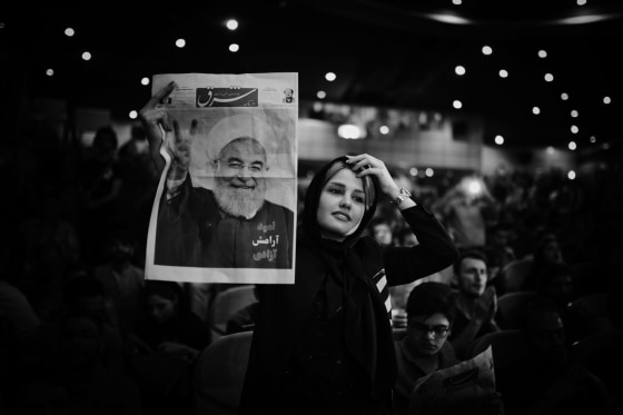 Image: A woman holds a photo of