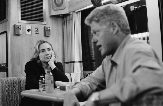 Image: On a campaign bus on their way from Portland to Seattle, American President Bill Clinton speaks with Washington state gubernatorial candidate Gary Locke, while First Lady Hillary Clinton watches, Washington, Sept. 20, 1996.