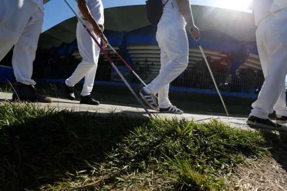 Image: The visually impaired arrive at the Changa Medero stadium for a baseball lesson, in Havana