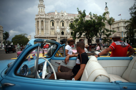 Image: Taxi drivers chat around their vintage American cars in Havana