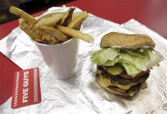 A cheeseburger and large fries from a Five Guys restaurant.