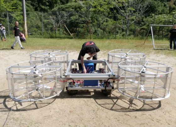 A staff member of Cartivator checks their flying car during a demonstration in Toyota
