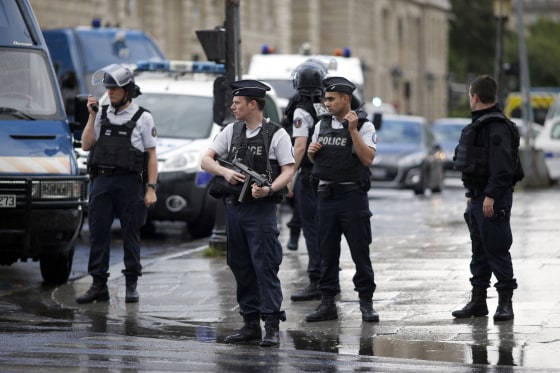 Image: Police officers seal off the access to Notre Dame cathedral in Paris