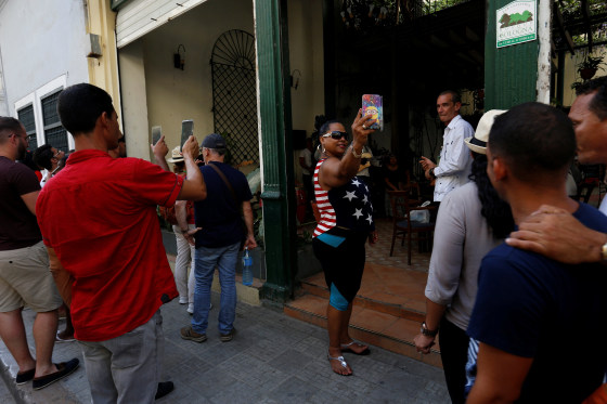 Image: Tourists take pictures in Havana