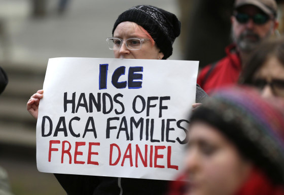 FILE - In this Feb. 17, 2017 file photo, a protester holds a sign that reads "ICE Hands Off DACA Families Free Daniel," during a demonstration in front of the federal courthouse in Seattle.