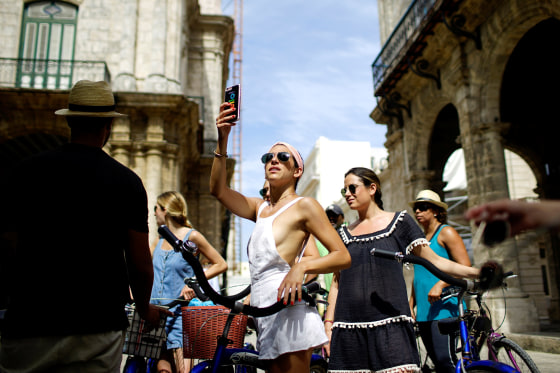 Image: Jamie Heifitz of the U.S. and her friends take a guided bicycle tour in Havana