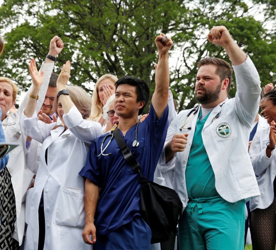 Image: Nancy Pelosi and healthcare workers react to remarks during an event protesting proposed Republican healthcare legislation