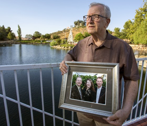 Image: Frank Kerrigan holds onto a photograph of his three children