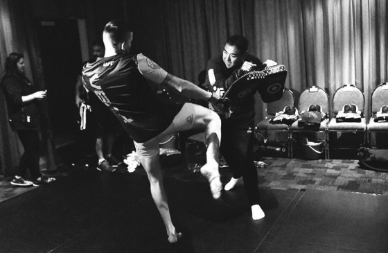 Colin Oyama, head coach at his Team Oyama MMA training center, working with one of his fighters.
