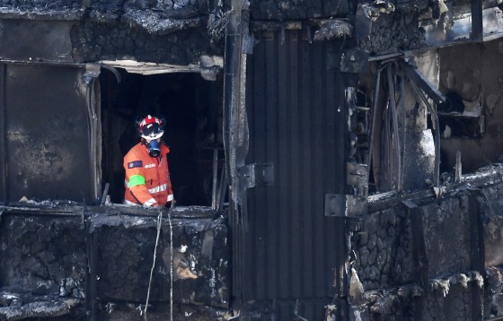 Image: A search and rescue worker inside Grenfell Tower