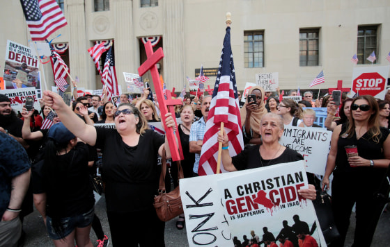Image: Protesters rally outside the federal court just before a hearing to consider a class-action lawsuit filed on behalf of Iraqi nationals facing deportation, in Detroit