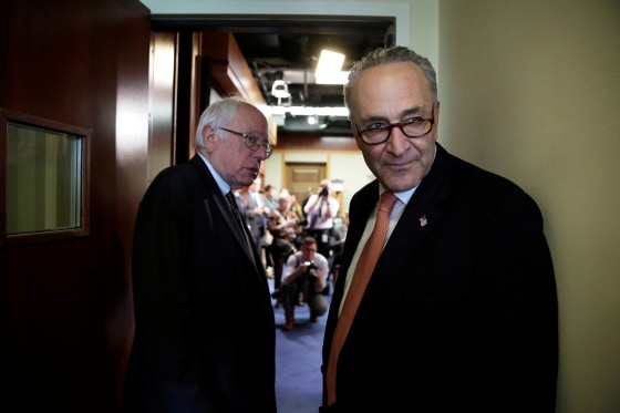 Image: Schumer and Sanders arrive at a news conference on release of the president's FY2018 budget proposal on Capitol Hill in Washington