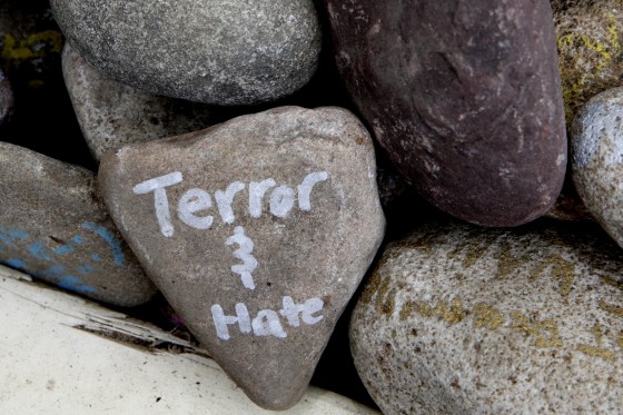 Image: A rock has the words \"terror and hate\" written on it at an art installation
