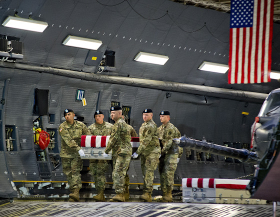 Image: Members of the Old Guard carry the transfer case of U.S. Army Sgt. Eric Houck to the transfer vehicle during the dignified transfer at Dover Air Force Base