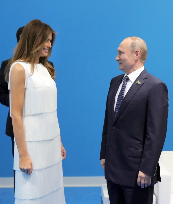 Image: Russian President Vladimir Putin (R) and US First Lady Melania Trump (L) meet
