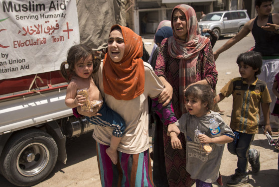 Image: Iraqi women and children fleeing the last fighters of ISIS in Mosul on Saturday.