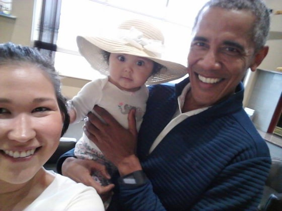 Image: Jolene Jackinsky, left, takes a selfie with her daughter Giselle and former U.S. President Barack Obama at Anchorage International Airport in Alaska.