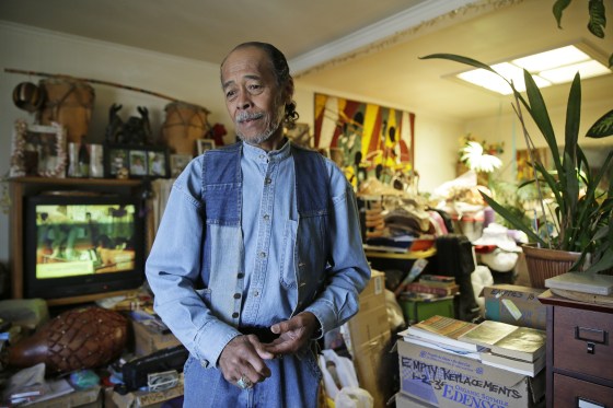Image: Graciano de la Cruz standing in his living room