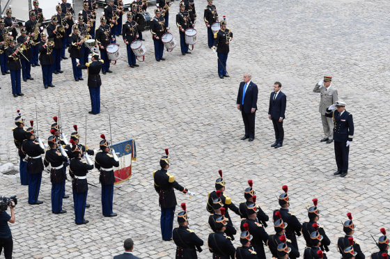 Image: President Donald Trump and French President Emmanuel Macron stand during a welcome ceremony
