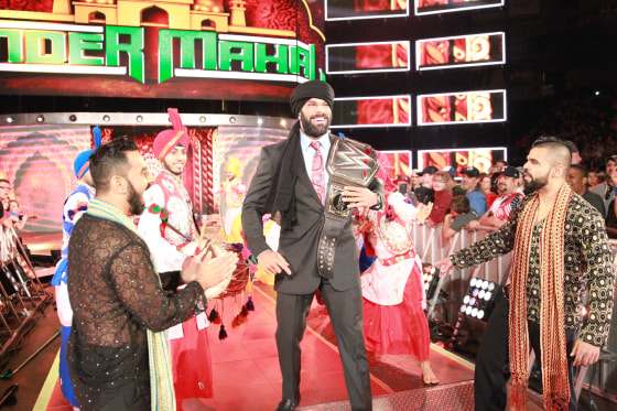 Professional wrestler Jinder Mahal (center) with his entourage, the Singh Brothers (front), celebrating his WWE Championship win.