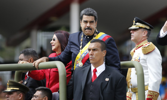 Venezuela's President Nicolas Maduro and first lady Cilia Flores ride in a vehicle during a military parade commemorating the country's Independence Day in Caracas, Venezuela, Wednesday, July 5, 2017.