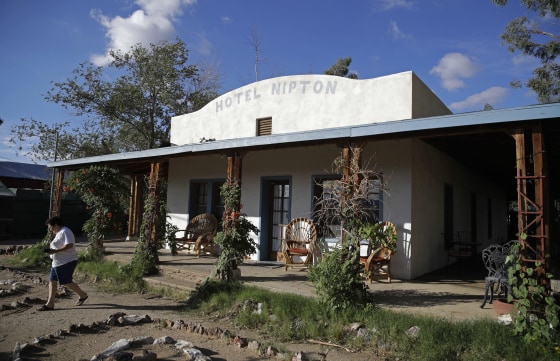 A woman walks out of the Hotel Nipton on Aug. 3, 2017, in Nipton, California.
