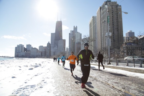 Mohan Iyer running a race along a frozen lake path in Chicago.