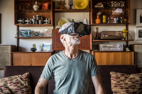 Man (60yrs) wearing virtual reality goggles
