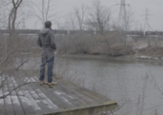 Director Cullen Hoback looks at iconic water tower in Flint, MI. Courtesy: What Lies Upstream