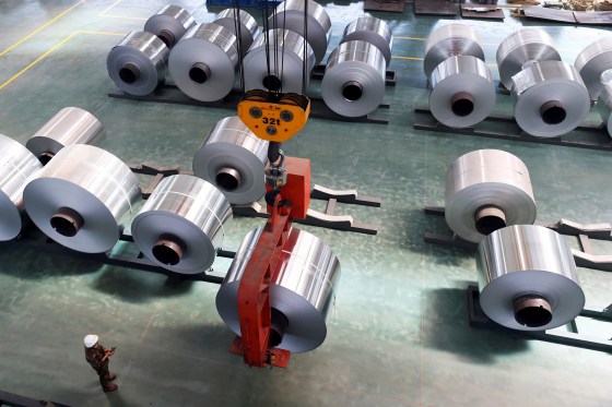 Image: An Employee Looks at an Aluminium Foil Roll Being Lifted at a Plant in Binzhou