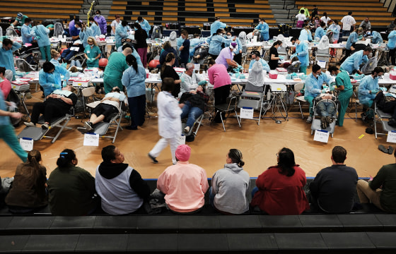 Image: People wait to see a dentist at the Remote Area Medical mobile dental and medical clinic in Milton, Florida