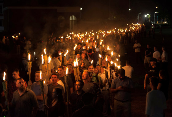 Image: White nationalists carry torches on the grounds of the University of Virginia, on the eve of a planned Unite The Right rally in Charlottesville