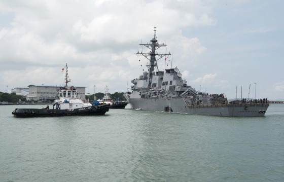 Image: Tugboats from Singapore assist the guided-missile destroyer USS John S. McCain as it steers towards Changi Naval Base, Singapore