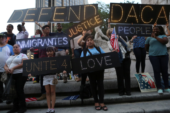 Image: People hold signs against U.S. President Donald Trump's proposed end of the DACA program that protects immigrant children from deportation at a protest in New York City