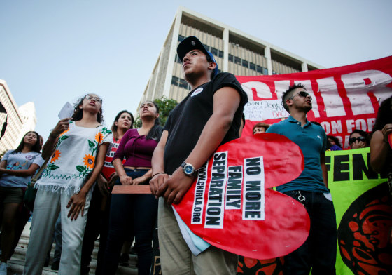 Image: Axel, 15, the son of a DACA program recipient, stands with supporters during a rally outside the Federal Building in Los Angeles