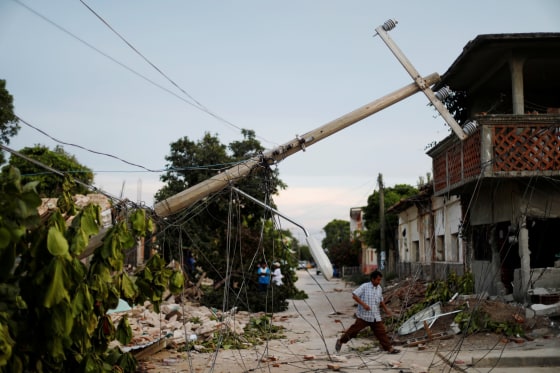 Image: A resident walks near earthquake debris in Juchitan, Mexico.