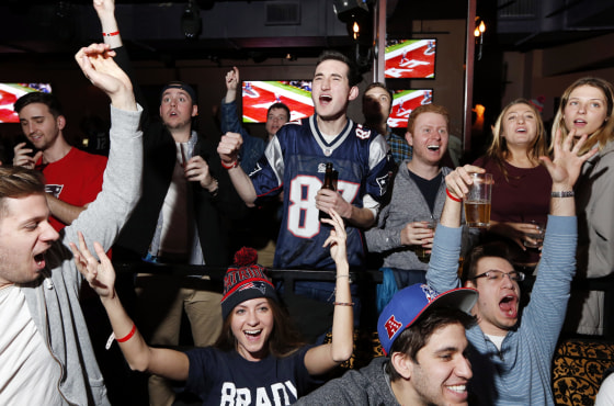 Fans at a Boston bar react while watching the first half of the Super Bowl in 2017.