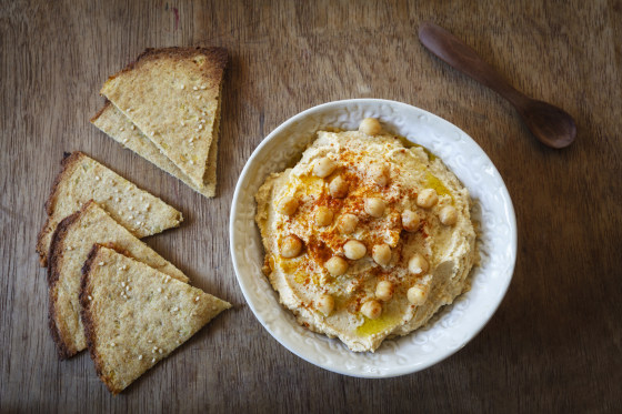 Bowl of Hummus and flat bread on wood