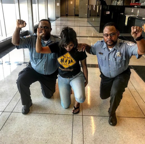 Image: Two Chicago police officers take a knee.