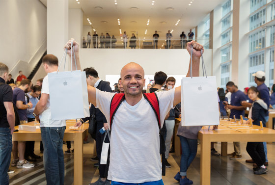 Image: A man stands with two bags of purchases at the iPhone 8 Launch at the 5th Avenue Apple Store