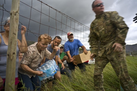 Image: Puerto Rican National Guard deliver food and water, brought via helicopter, to residents of Morovis, Puerto Rico