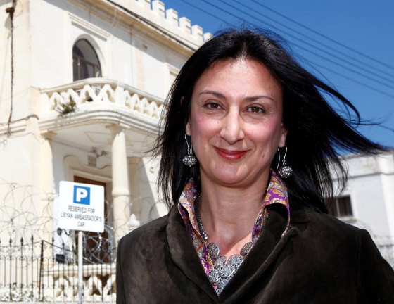 Image: Maltese investigative journalist Daphne Caruana Galizia poses outside the Libyan Embassy in Valletta