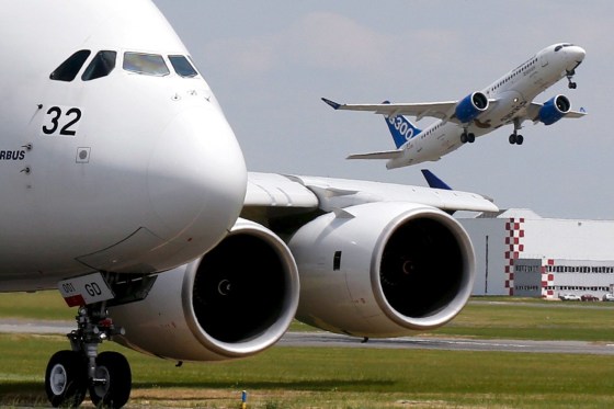 Image: A Bombardier CS300 aicraft takes as an Airbus A380 waits on the taxiway in this 2015 file photo.