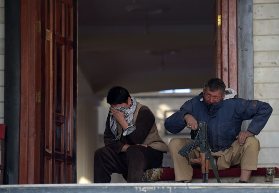Image: Afghan men weep inside the Imam Zaman Shiite mosque the day after a suicide attack during Friday evening prayers, in Kabul on October 21, 2017.