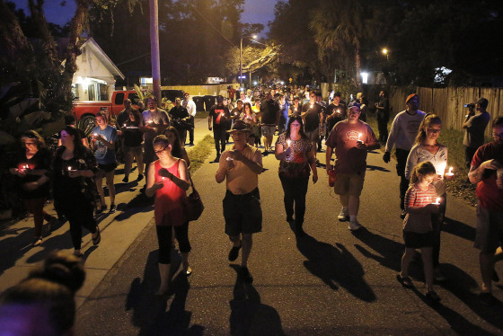 Image: A peaceful march that began on east New Orleans Avenue was held during a candlelight vigil