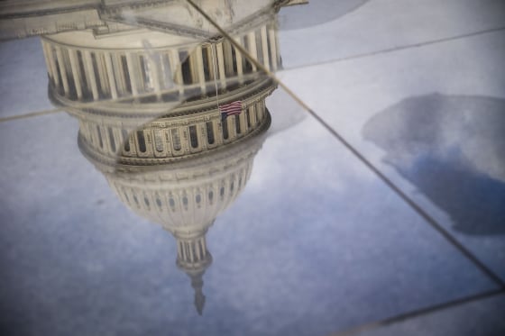 Image: The U.S. Capitol, seen in a reflection, in the morning in Washington.